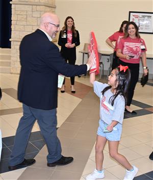rep. jon rosenthal high-fives a rennell elementary school student during school priority day.
